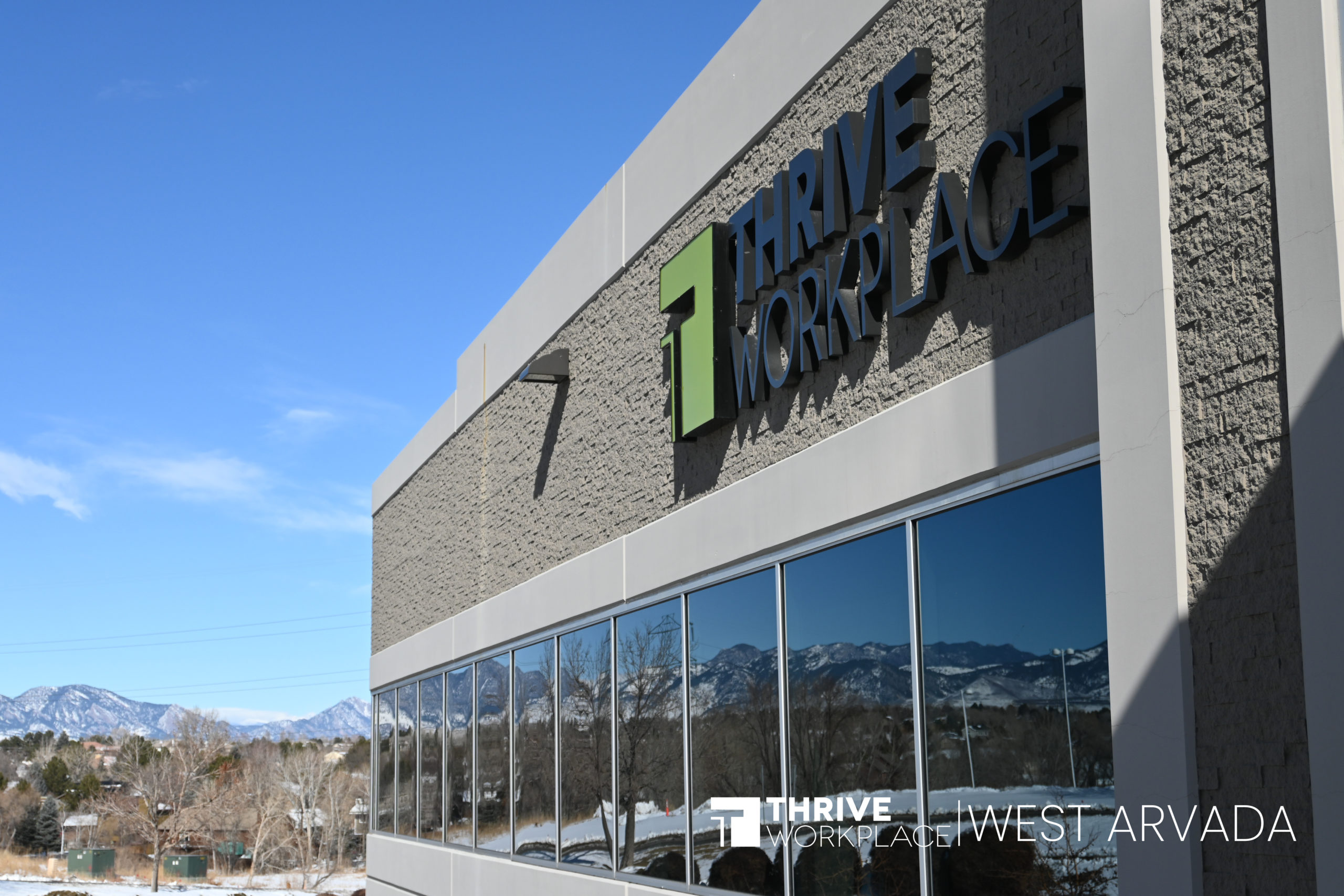 A Photo of Thrive Workplace West Arvada with the mountainscape and sign.